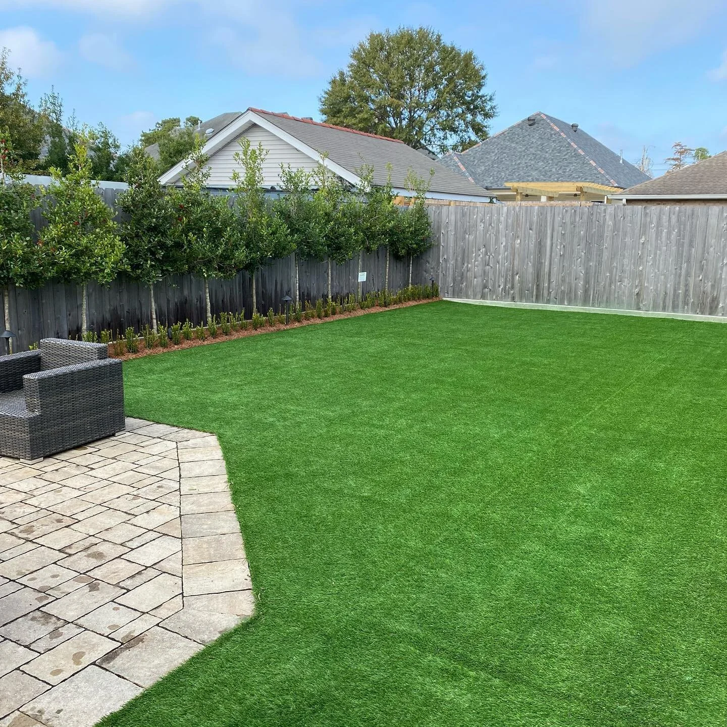 Beautiful landscape design with artificial turf installed in a Frisco backyard
